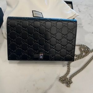 Gucci embossed monogram purse